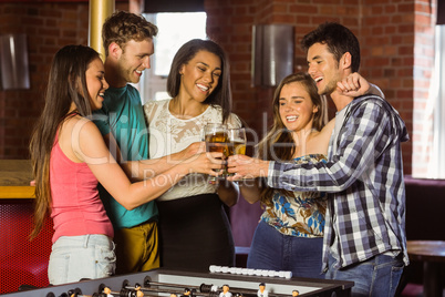 Portrait of happy friends toasting with mixed drink and beer