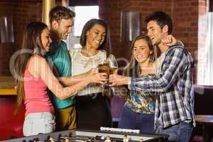 Portrait of happy friends toasting with mixed drink and beer