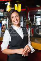 Happy barmaid smiling at camera