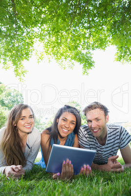 Happy students using tablet pc outside Happy students using tablet pc outside