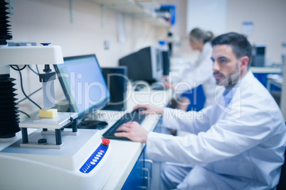 Food scientist using technology to analyse cheese