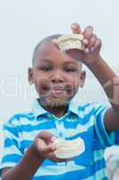 Portrait of boy holding mouth model