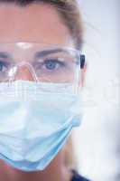 Close up of a dentist in mask looking at camera