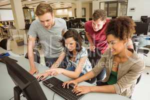 Classmates working together in the computer room