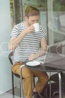 Smiling student drinking hot drink
