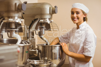 Baker using large mixer to mix dough