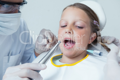 Close up of girl having her teeth examined