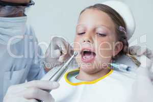 Close up of girl having her teeth examined