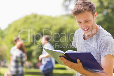 Handsome student studying outside on campus