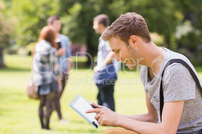 Handsome student studying outside on campus