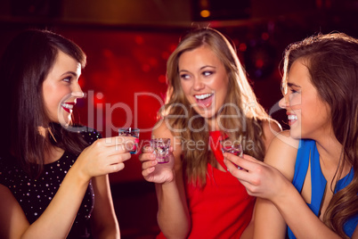 Pretty friends drinking shots together