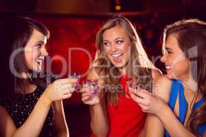 Pretty friends drinking shots together