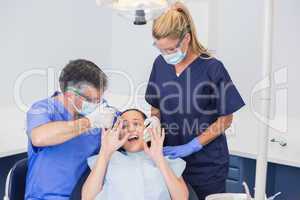 Dentist doing injection and patient protesting