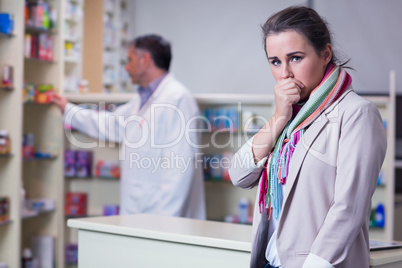 Portrait of a sick girl with scarf looking at camera