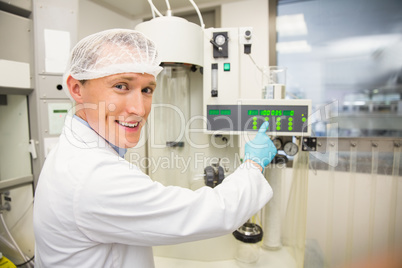 Pharmacist using machinery to make medicine