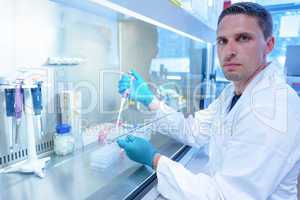 Science student using pipette in the lab