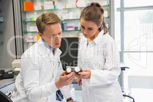 Team of pharmacists looking at medicine