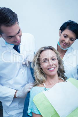 Portrait of dentist with assistant and female patient Portrait of dentist with assistant and female patient