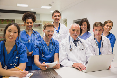 Medical students and professor smiling at camera