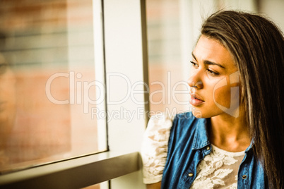 Pretty brunette sitting alone unsmiling