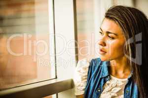 Pretty brunette sitting alone unsmiling