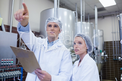 Man pointing at something to his colleague