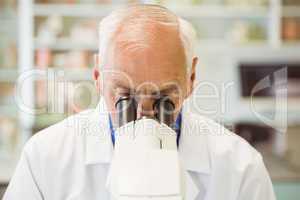 Senior scientist working with microscope