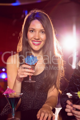 Pretty brunette drinking a cocktail