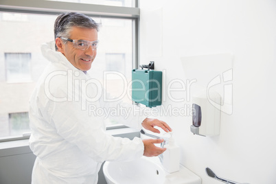 Pharmacist washing his hands at sink