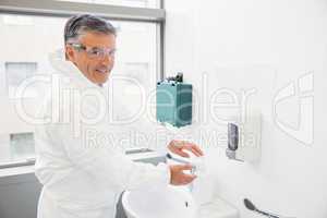 Pharmacist washing his hands at sink