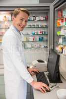 Handsome pharmacist using the computer