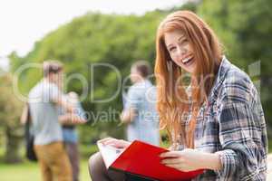 Pretty student studying outside on campus