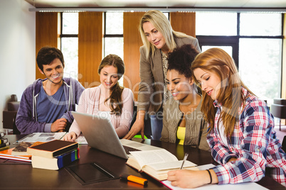 Professor teaching group of students in library