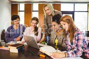 Professor teaching group of students in library