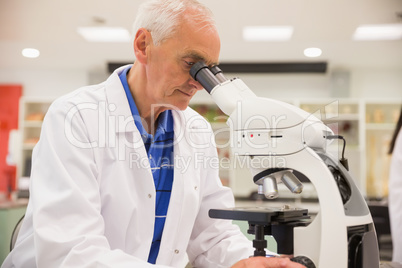 Medical professor working with microscope
