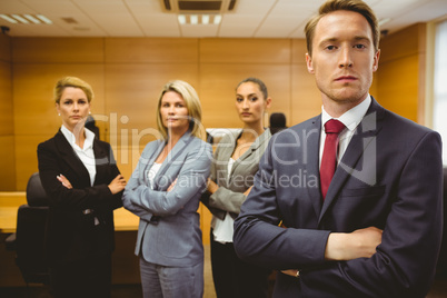 Serious lawyer standing with arms crossed