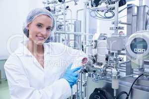 Smiling scientist leaning against gauge