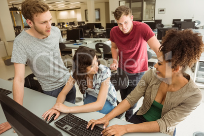 Classmates working together in the computer room