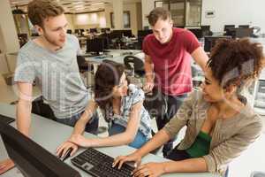 Classmates working together in the computer room