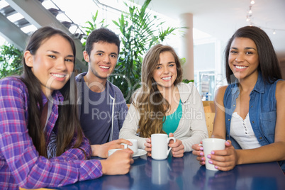 Young students having coffee together