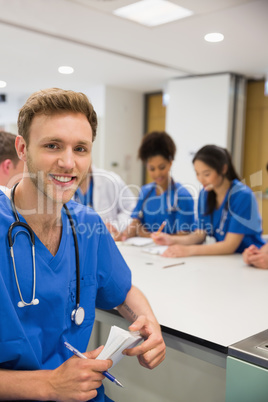 Medical student smiling at the camera during class