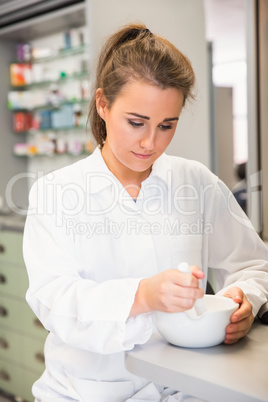 Junior pharmacist mixing a medicine