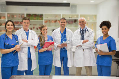 Medical professor smiling at camera with students