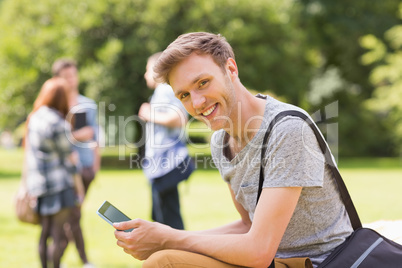 Handsome student studying outside on campus