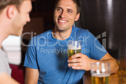 Happy friends catching up over pints