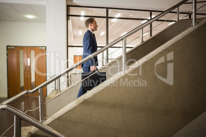 Businessman climbing up the stairs