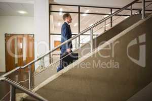 Businessman climbing up the stairs