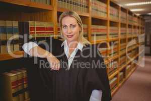 Smiling lawyer leaning on shelf