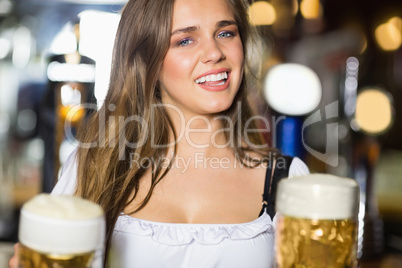 Smiling oktoberfest barmaid with beer