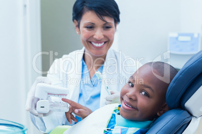 Dentist showing boy prosthesis teeth